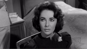 Movie still from “Suddenly, Last Summer” (1959), directed by Joseph L. Mankiewicz – An old black and white photo of a woman in a black dress; Close Up shot, High angle