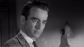 Movie still from “Suddenly, Last Summer” (1959), directed by Joseph L. Mankiewicz – Black and white photograph of a man in a suit and tie; Close Up shot, Low angle