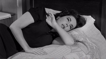Movie still from “Suddenly, Last Summer” (1959), directed by Joseph L. Mankiewicz – A black and white photo of a woman laying on a bed; Medium shot, High angle