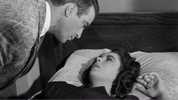 Movie still from “Suddenly, Last Summer” (1959), directed by Joseph L. Mankiewicz – A man and a woman laying on a bed looking at each other; Close Up shot, High angle