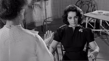 Movie still from “Suddenly, Last Summer” (1959), directed by Joseph L. Mankiewicz – An old black and white photo of a woman talking to another woman; Close Up shot, Over the shoulder angle