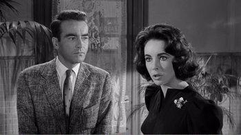 Movie still from “Suddenly, Last Summer” (1959), directed by Joseph L. Mankiewicz – A man and a woman standing next to each other; Close Up shot, Over the shoulder angle