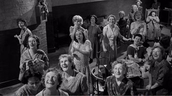 Movie still from “Suddenly, Last Summer” (1959), directed by Joseph L. Mankiewicz – A group of women are laughing together in a room; Wide shot, High angle