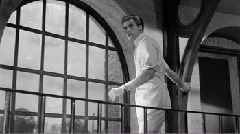 Movie still from “Suddenly, Last Summer” (1959), directed by Joseph L. Mankiewicz – A black and white photo of a man standing on top of a railing; Medium shot, Low angle