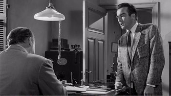 Movie still from “Suddenly, Last Summer” (1959), directed by Joseph L. Mankiewicz – A black and white photo of a man standing in front of another man; Medium shot, Over the shoulder angle