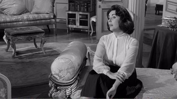 Movie still from “Suddenly, Last Summer” (1959), directed by Joseph L. Mankiewicz – A woman sitting on the ground in a living room; Medium shot, Low angle