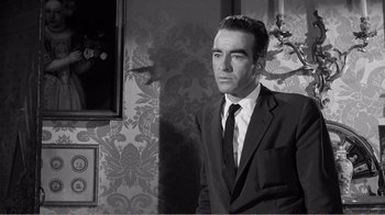 Movie still from “Suddenly, Last Summer” (1959), directed by Joseph L. Mankiewicz – Black and white photograph of a man wearing a suit and tie; Medium shot, Low angle