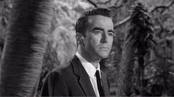 Movie still from “Suddenly, Last Summer” (1959), directed by Joseph L. Mankiewicz – Black and white photograph of a man wearing a suit and tie; Close Up shot, Low angle