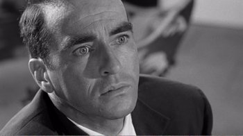 Movie still from “Suddenly, Last Summer” (1959), directed by Joseph L. Mankiewicz – Black and white photograph of a man looking at the camera; Close Up shot, Low angle
