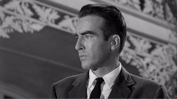 Movie still from “Suddenly, Last Summer” (1959), directed by Joseph L. Mankiewicz – Black and white photograph of a man wearing a suit and tie; Close Up shot, Low angle