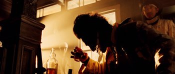 Movie still from “Sukiyaki Western Django” (2007), directed by Takashi Miike – A person smoking a cigarette in front of a window; Close Up shot, Low angle