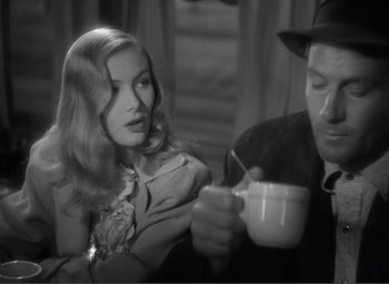 Movie still from “Sullivan's Travels” (1941), directed by Preston Sturges – A man and a woman sitting at a table drinking coffee; Close Up shot, Over the shoulder angle