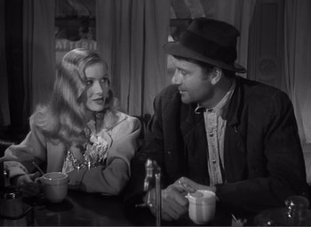Movie still from “Sullivan's Travels” (1941), directed by Preston Sturges – A man and a woman sitting at a table with coffee cups; Medium shot, Over the shoulder angle