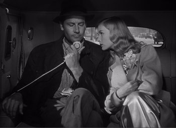Movie still from “Sullivan's Travels” (1941), directed by Preston Sturges – A man and a woman sitting in the back of a car; Close Up shot, Low angle