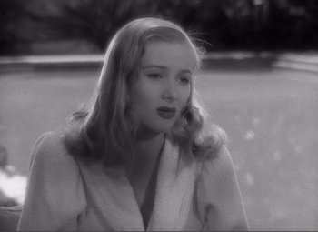 Movie still from “Sullivan's Travels” (1941), directed by Preston Sturges – A black - and - white photo of a woman with long blonde hair; Close Up shot, Over the shoulder angle