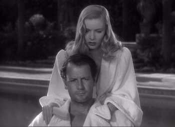 Movie still from “Sullivan's Travels” (1941), directed by Preston Sturges – A man and a woman are sitting in a pool; Close Up shot, Low angle