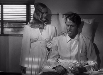 Movie still from “Sullivan's Travels” (1941), directed by Preston Sturges – A man and a woman sitting on a bed; Medium shot, Low angle