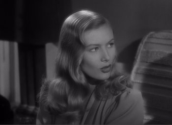 Movie still from “Sullivan's Travels” (1941), directed by Preston Sturges – A black - and - white photo of a woman with long blonde hair; Close Up shot, Over the shoulder angle