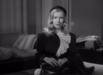 Movie still from “Sullivan's Travels” (1941), directed by Preston Sturges – A black and white photo of a woman wearing a hat; Medium shot, Low angle