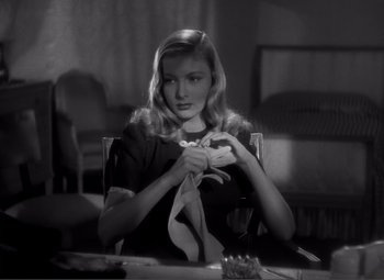 Movie still from “Sullivan's Travels” (1941), directed by Preston Sturges – A black and white photo of a woman holding a banana peel; Close Up shot, Over the shoulder angle