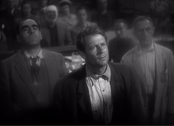 Movie still from “Sullivan's Travels” (1941), directed by Preston Sturges – Black and white photograph of men in suits and ties; Medium shot, Low angle