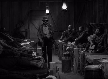 Movie still from “Sullivan's Travels” (1941), directed by Preston Sturges – A group of men sitting around in a room; Wide shot, High angle