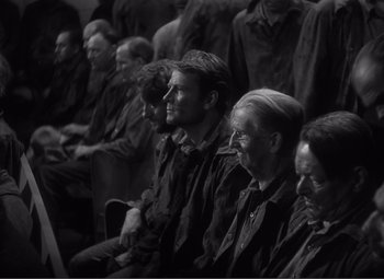 Movie still from “Sullivan's Travels” (1941), directed by Preston Sturges – A black and white photo of a group of people; Medium shot, High angle