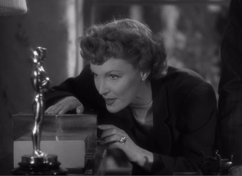 Movie still from “Sullivan's Travels” (1941), directed by Preston Sturges – An old photo of a woman leaning over a table; Close Up shot, Low angle