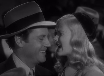 Movie still from “Sullivan's Travels” (1941), directed by Preston Sturges – A man and a woman smiling at each other in a black and white photo; Close Up shot, High angle