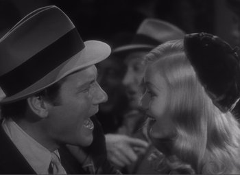 Movie still from “Sullivan's Travels” (1941), directed by Preston Sturges – A man and a woman in a crowd of onlookers; Close Up shot, High angle