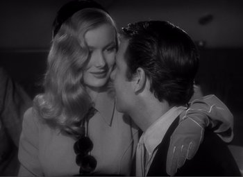 Movie still from “Sullivan's Travels” (1941), directed by Preston Sturges – A man and a woman kissing each other in a black and white photo; Close Up shot, Over the shoulder angle