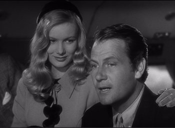 Movie still from “Sullivan's Travels” (1941), directed by Preston Sturges – A man and a woman are standing next to each other; Close Up shot, Over the shoulder angle