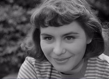 Movie still from “Summer Interlude” (1951), directed by Ingmar Bergman – A black - and - white photo of a woman smiling; Close Up shot, High angle