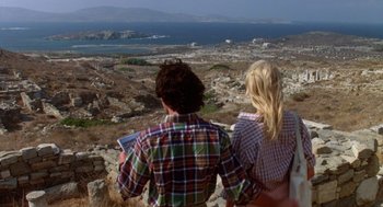 Movie still from “Summer Lovers” (1982), directed by Randal Kleiser – A man and a woman looking out at the ocean; Wide shot, High angle