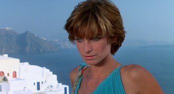 Movie still from “Summer Lovers” (1982), directed by Randal Kleiser – A person wearing a blue shirt; Close Up shot, Low angle