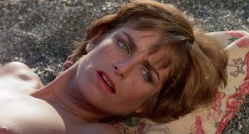 Movie still from “Summer Lovers” (1982), directed by Randal Kleiser – A person laying on the ground; Close Up shot, High angle