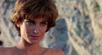 Movie still from “Summer Lovers” (1982), directed by Randal Kleiser – A person with short hair; Close Up shot, Low angle