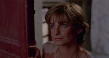 Movie still from “Summer Lovers” (1982), directed by Randal Kleiser – A person wearing a necklace; Close Up shot, Low angle