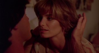 Movie still from “Summer Lovers” (1982), directed by Randal Kleiser – A person with short brown hair; Close Up shot, Over the shoulder angle