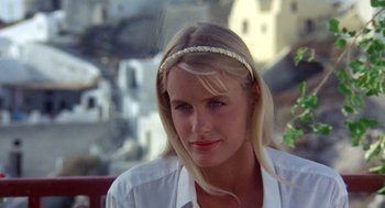 Movie still from “Summer Lovers” (1982), directed by Randal Kleiser – A beautiful blonde woman wearing a white shirt; Close Up shot, High angle
