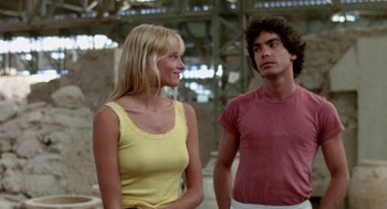 Movie still from “Summer Lovers” (1982), directed by Randal Kleiser – A man and a woman standing next to each other; Medium shot, Low angle