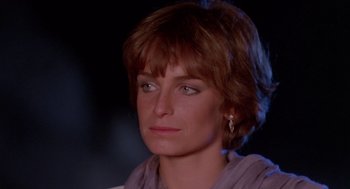 Movie still from “Summer Lovers” (1982), directed by Randal Kleiser – A person with short brown hair; Close Up shot, Low angle