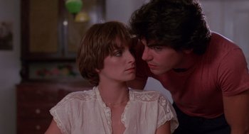 Movie still from “Summer Lovers” (1982), directed by Randal Kleiser – A man and a woman looking at one another; Close Up shot, Over the shoulder angle