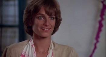 Movie still from “Summer Lovers” (1982), directed by Randal Kleiser – A person smiling; Close Up shot, High angle