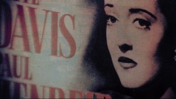 Movie still from “Summer of '42” (1971), directed by Robert Mulligan – A woman's face on a poster; Extreme Close Up shot, Overhead angle