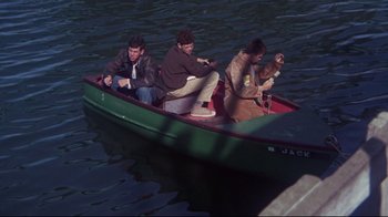 Movie still from “Summer of '42” (1971), directed by Robert Mulligan – A group of people in a boat on a body of water; Wide shot, High angle