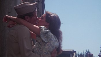 Movie still from “Summer of '42” (1971), directed by Robert Mulligan – A man and a woman kissing each other; Medium shot, Low angle