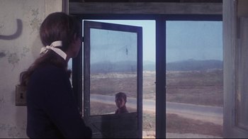 Movie still from “Summer of '42” (1971), directed by Robert Mulligan – A person standing in front of an open window; Medium shot, Over the shoulder angle