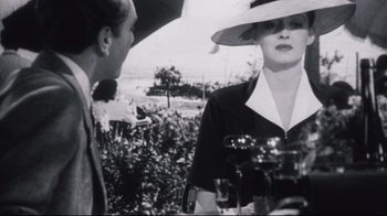 Movie still from “Summer of '42” (1971), directed by Robert Mulligan – An old photo of a man and a woman talking; Medium shot, Over the shoulder angle