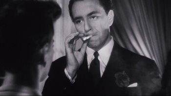 Movie still from “Summer of '42” (1971), directed by Robert Mulligan – A black and white photo of a man in a suit and tie; Close Up shot, Low angle